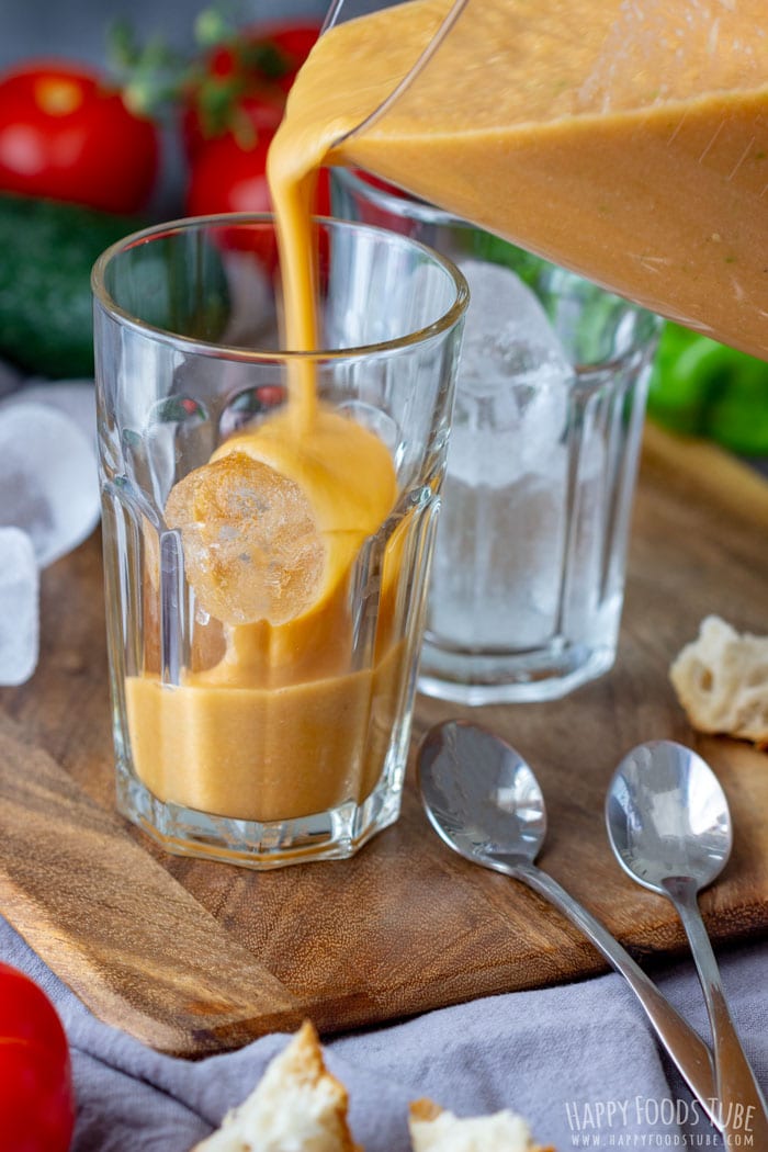 Pouring cold Tomato Gazpacho Soup to the glass