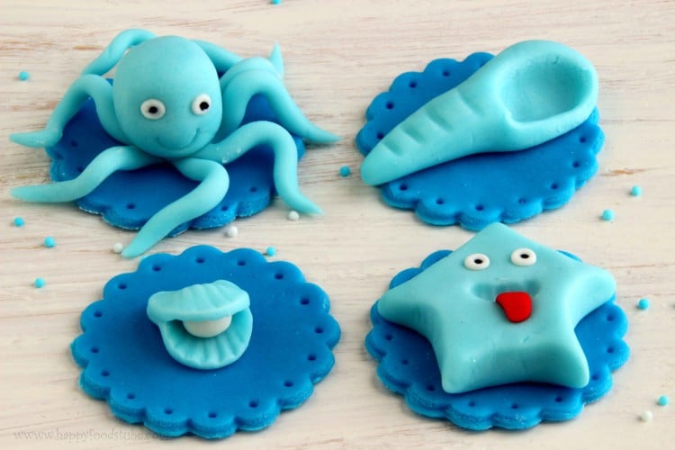 Sea World Cupcake Toppers - Easy fondant cake decorating tutorial. Learn how to make Star fish, Long shell, Oyster shell and Octopus | happyfoodstube.com