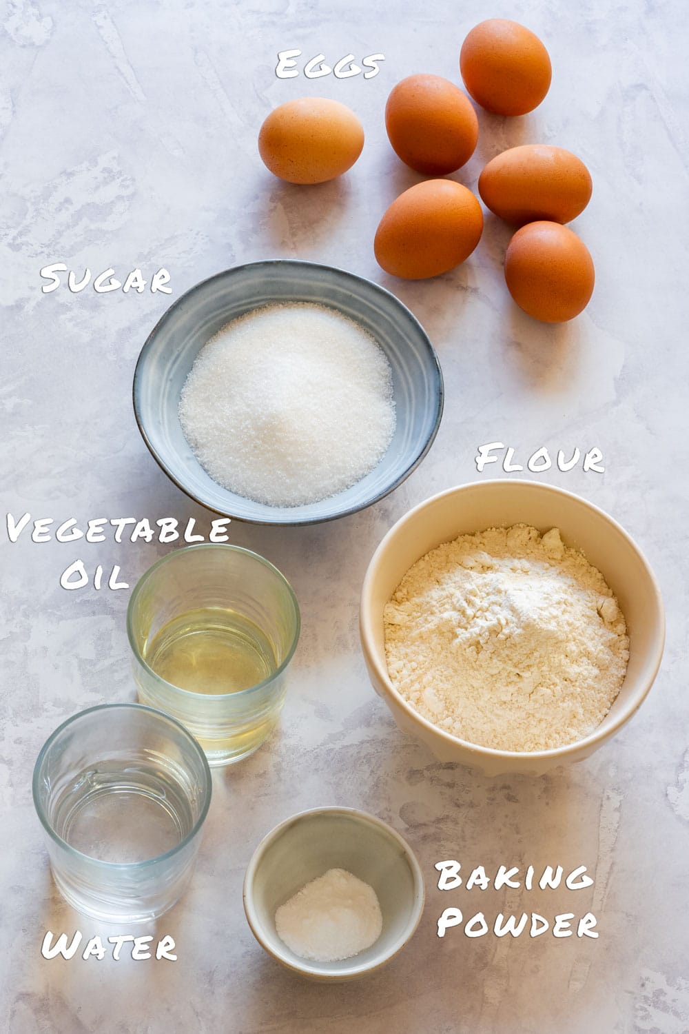 Ingredients for sponge cake - eggs, flour, sugar, baking powder, vegetable oil and water.