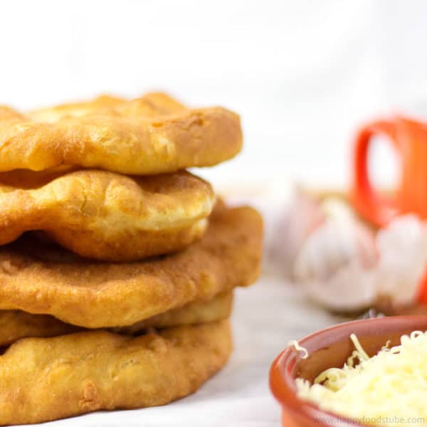 Langos is a Hungarian deep fried flat bread (made of yeast, flour & water) that is eaten while still warm. | happyfoodstube.com