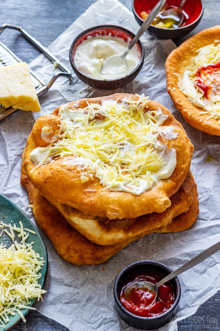 Langos topped with sour cream and cheese