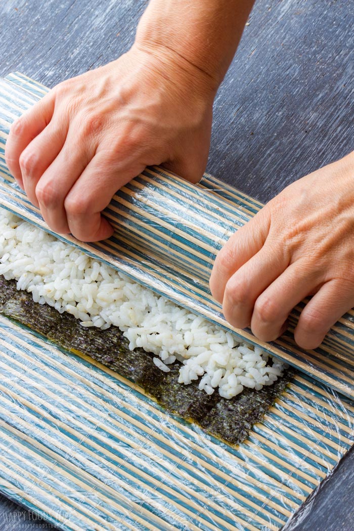 How to make Homemade Sushi Step 3 - Carefully roll it altogether with nori sheet over the fillings