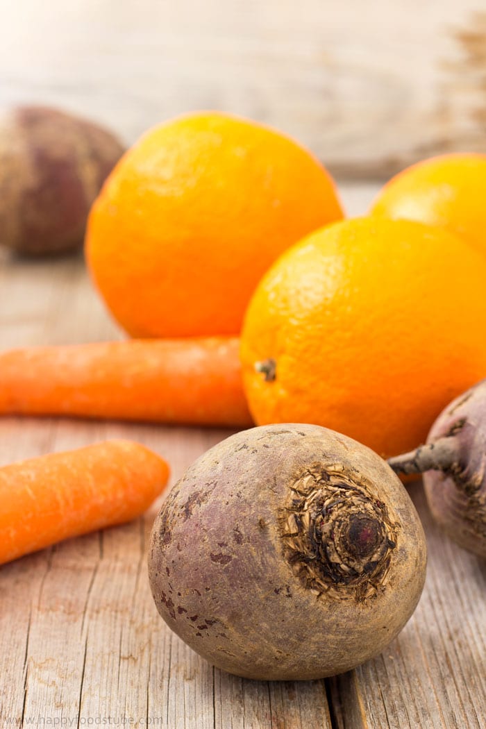 Raw beets, carrots and oranges for juicing.