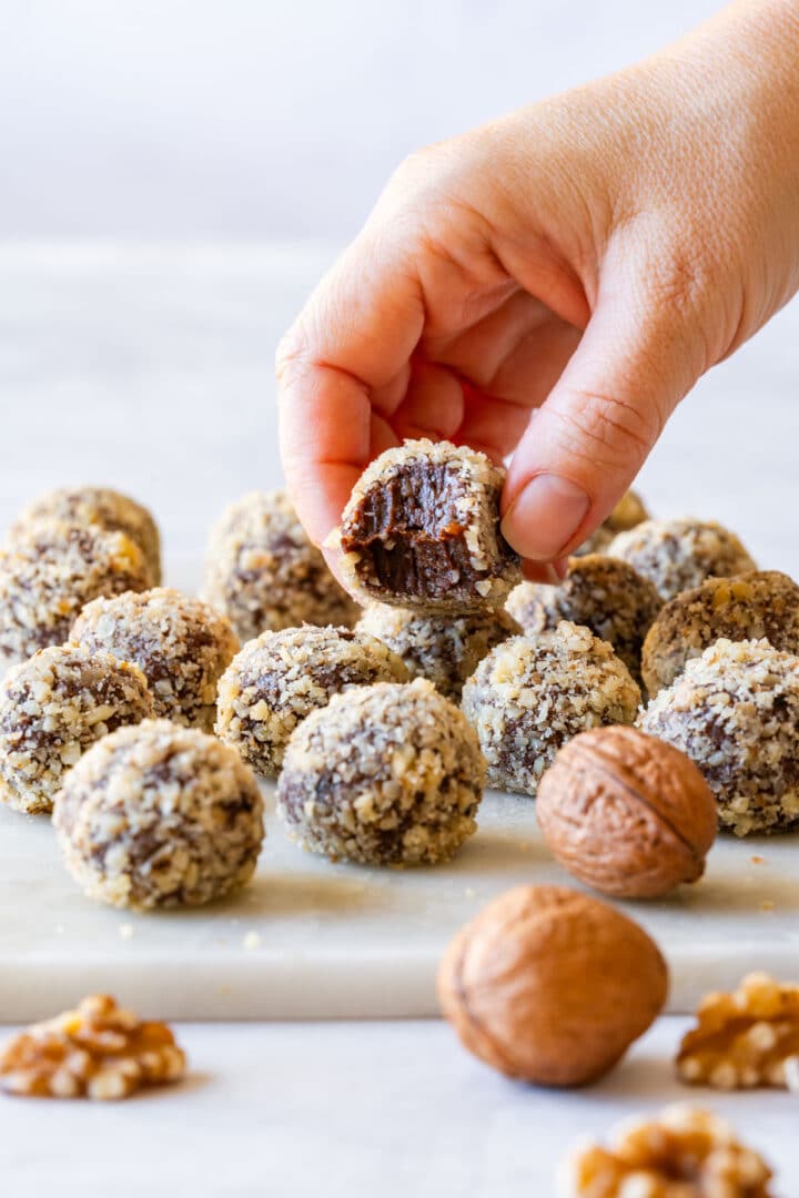 Chocolate balls with nuts (walnut truffles) with a rich, fudgy center.
