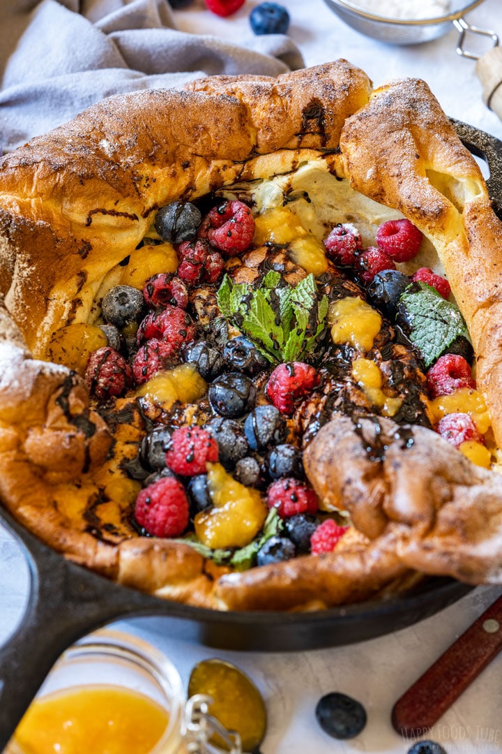 Oven baked German pancake with choclate sauce and berries