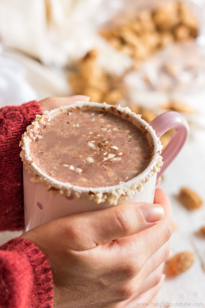 Holding freshly made hot cocoa with both hands