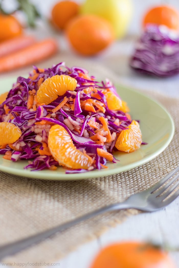 Colorful red cabbage salad with mandarin oranges on the plate.