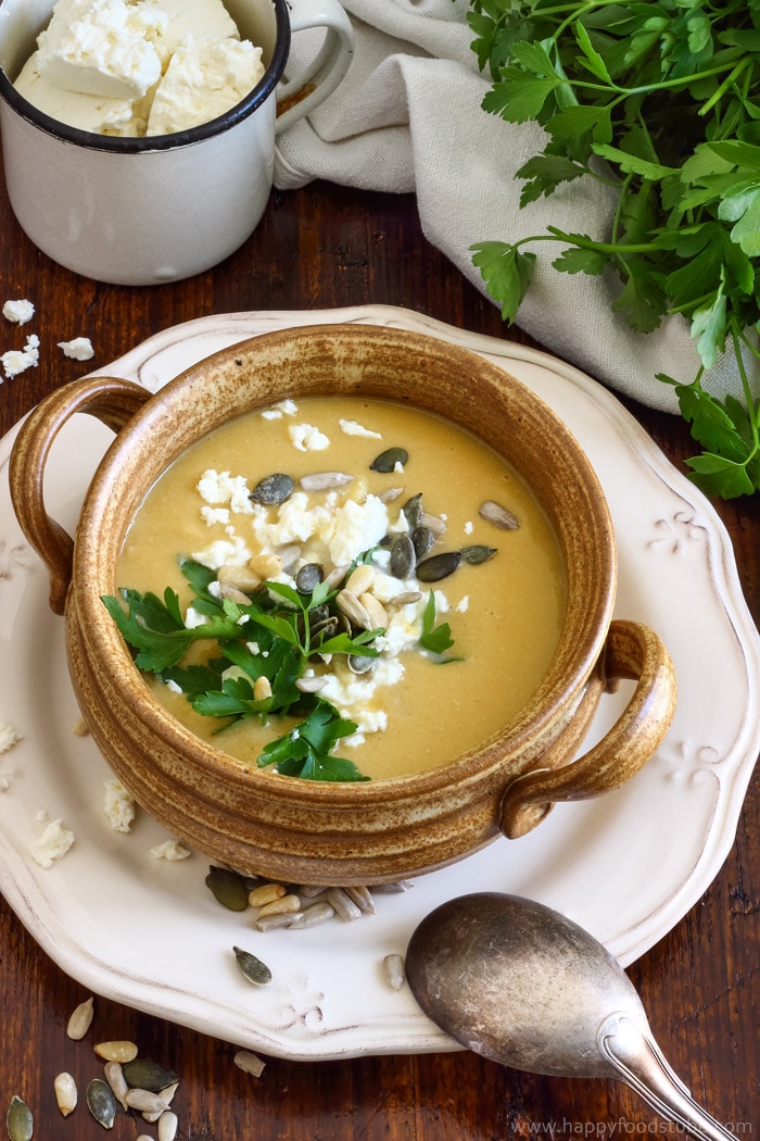 Bowl of homemade chickpea soup topped with parsley and seeds