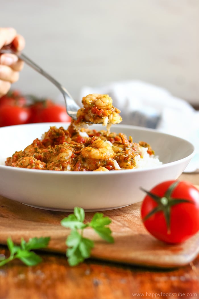Julia forking shrimp and rice with tomato salsa from the white bowl.