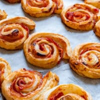 Homemade puff pastry bacon pinwheels with cheese.