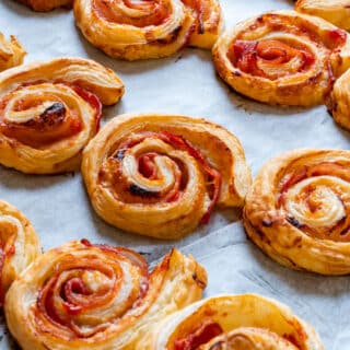 Homemade puff pastry bacon pinwheels with cheese.