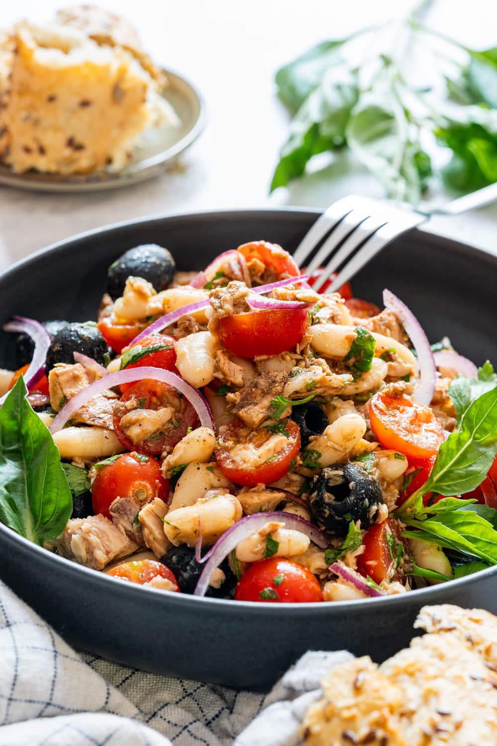 Plate with tuna white bean salad served with bread.