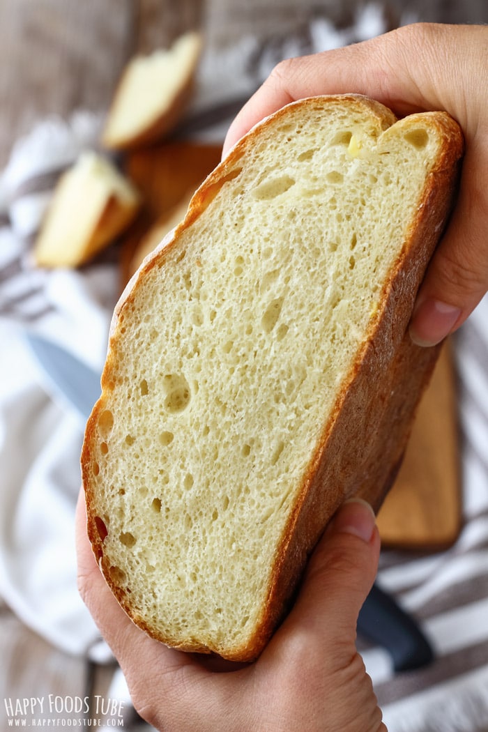 Holding the potato bread loaf, showing the texture and softness