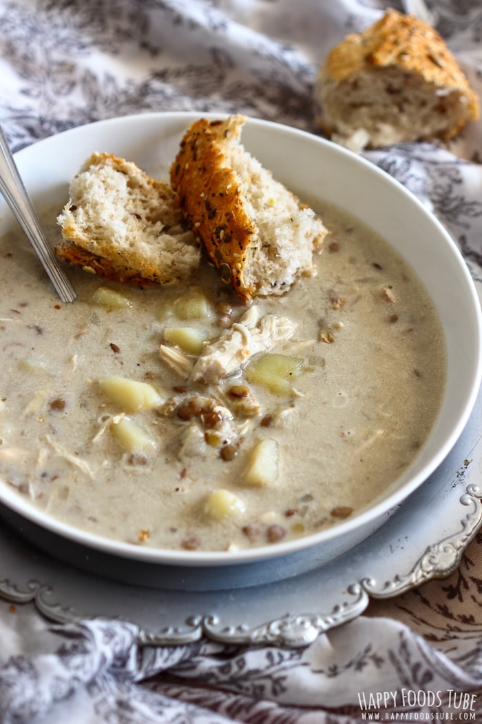 A bowl of Instant Pot Chicken Lentil Soup with fresh bread
