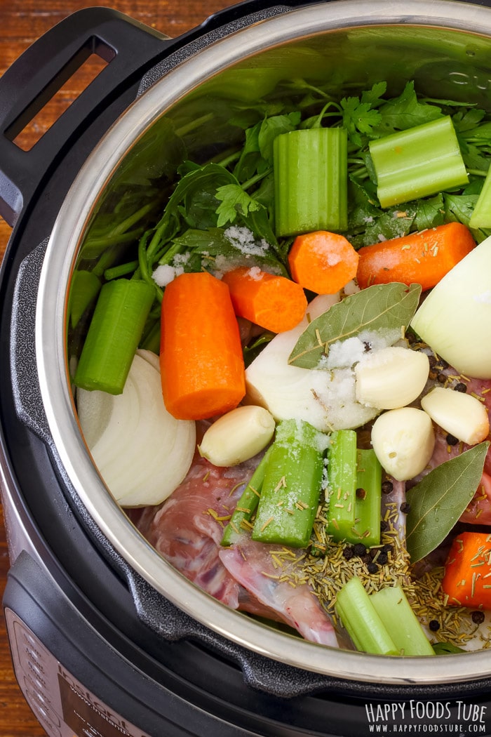Vegetables and raw chicken pieces in the Instant Pot