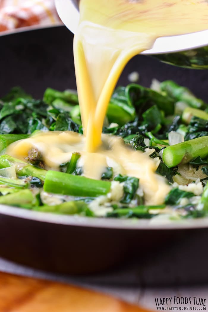 Pouring egg mix to the Spinach and Asparagus Frittata