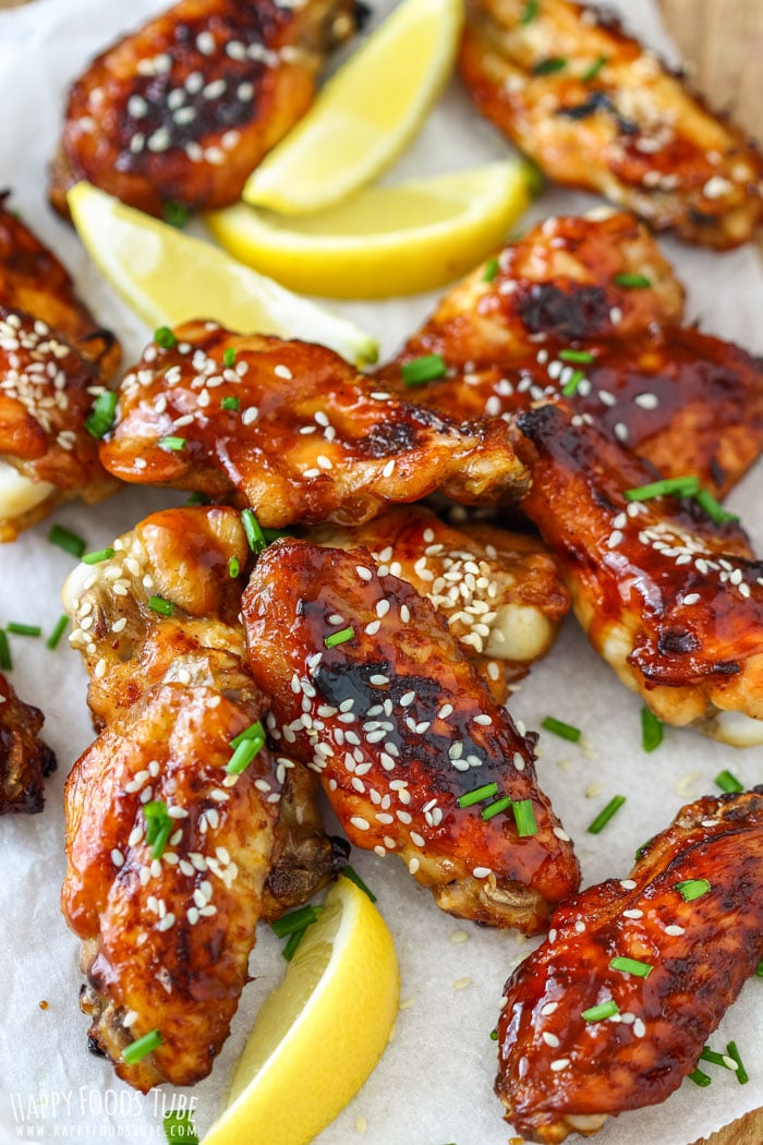 Baked Sticky Hoisin Chicken Wings carnished wiht chives, sesame seeds and lemons