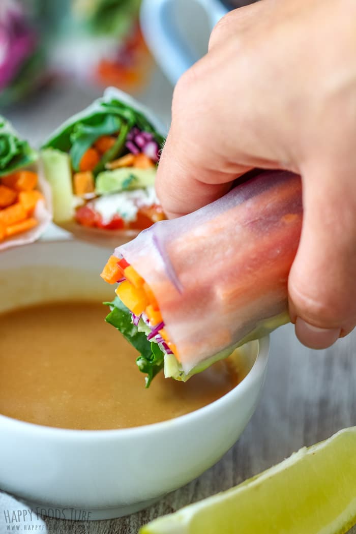 Dipping Vegetarian Fresh Spring Rolls into Peanut Sauce