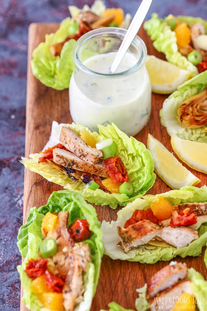 Mediterranean Chicken Lettuce Wraps and Greek yogurt dressing on the wooden board