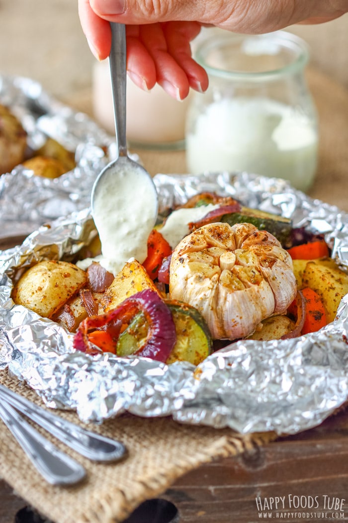 Topping the Vegetable Foil Packets with white sauce