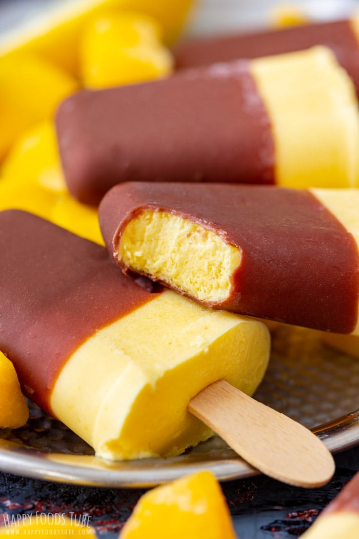 Delicious frozen Mango Yogurt Popsicles with bite taken