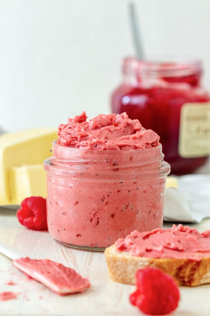 Homemade Raspberry Butter jar and slice of bread with raspberry butter spread