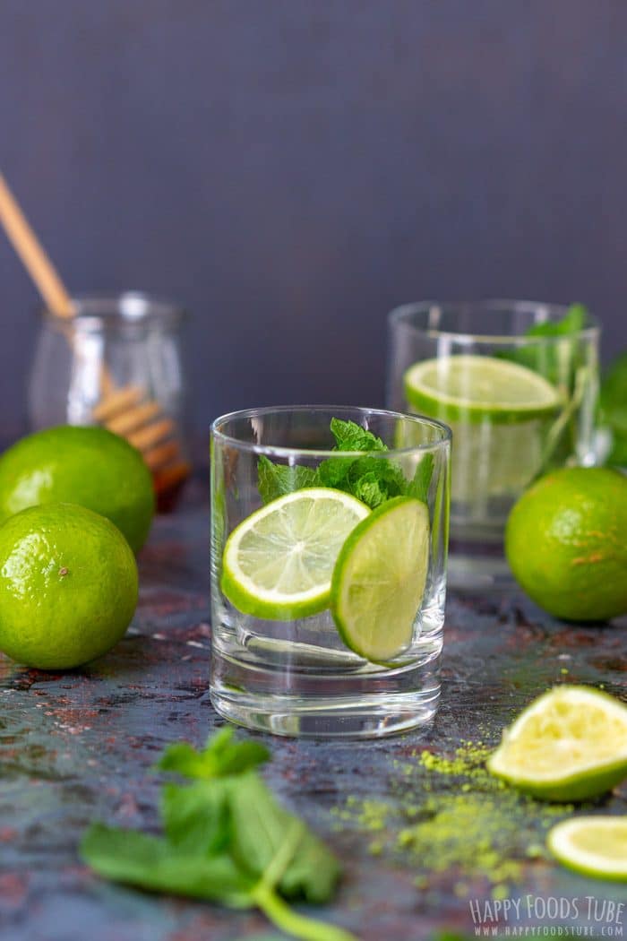 Empty glass prepared with lime slices and fresh mint leaves.