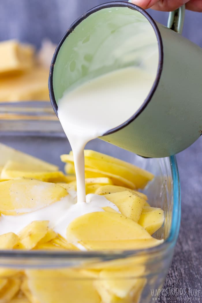 Pouring Cream to the Potatoes Au Gratin