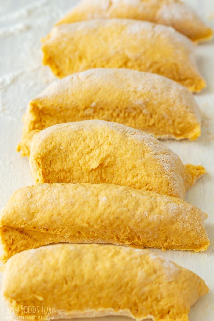 Portions of pumpkin flatbread dough cut and ready to roll.