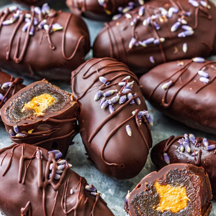 Close-up of chocolate-covered dates filled with peanut butter, showing a chewy and rich texture.