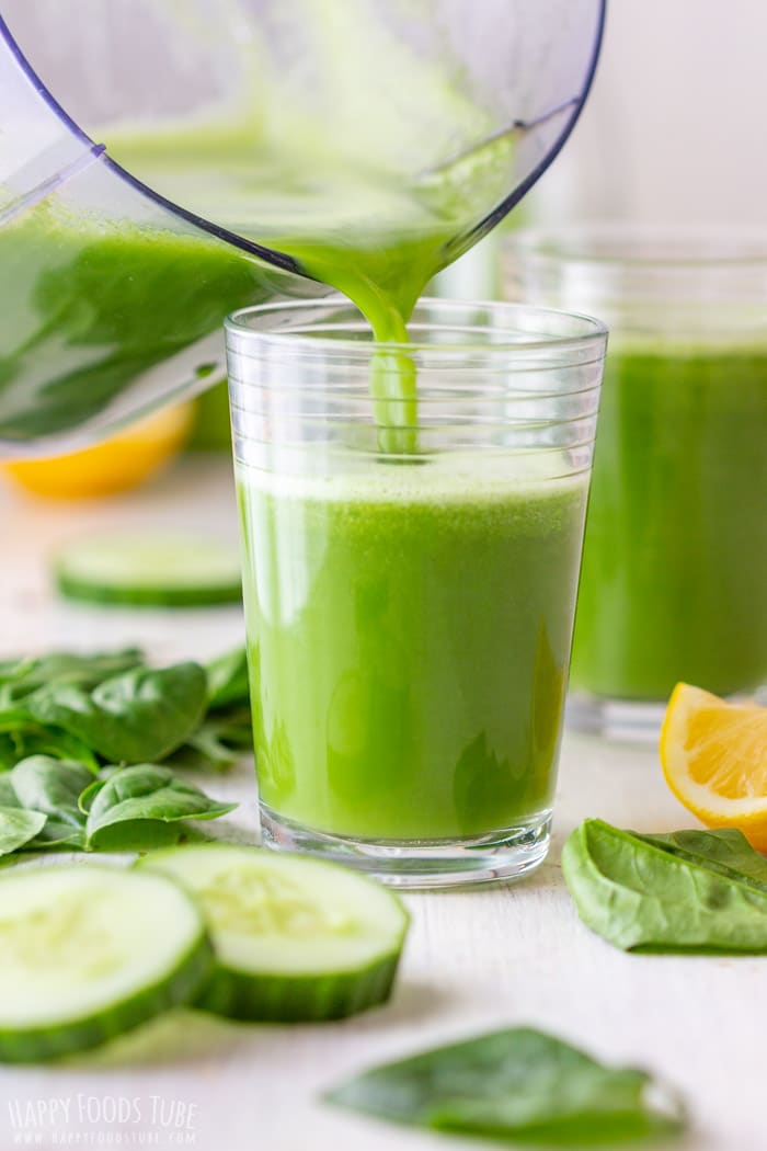 Pouring freshly made green juice to the glass.