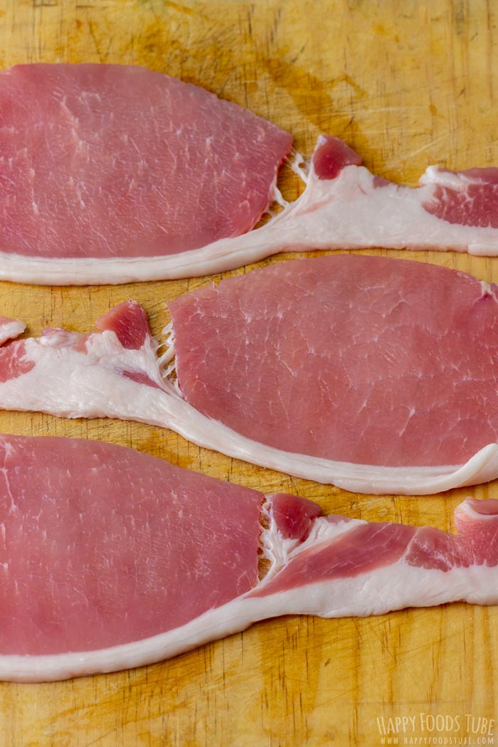 Irish bacon rashers on a wooden cutting board.