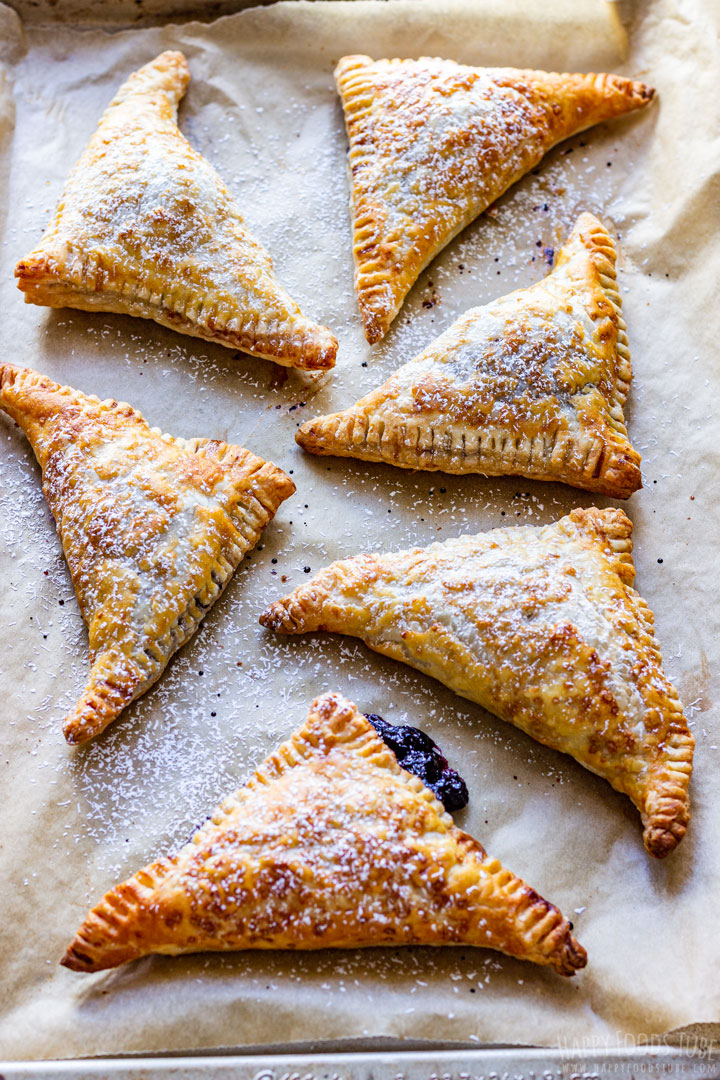 Freshly baked blueberry turnovers on the baking tray