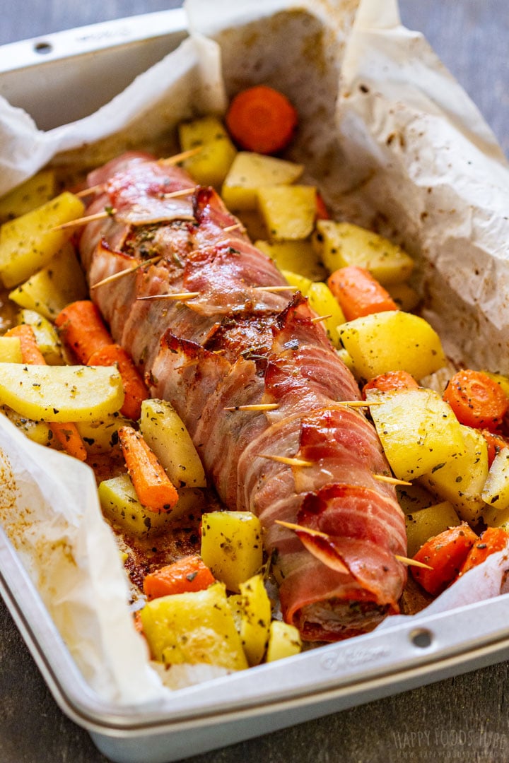 Oven roasted bacon wrapped pork tenderloin with potatoes and carrots