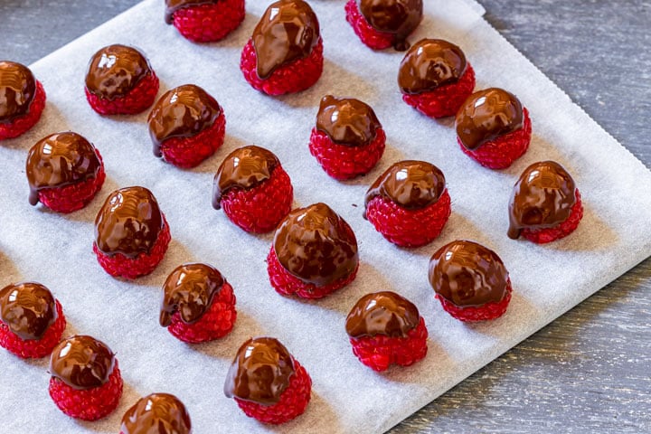 Chocolate dipped raspberries on the tray.