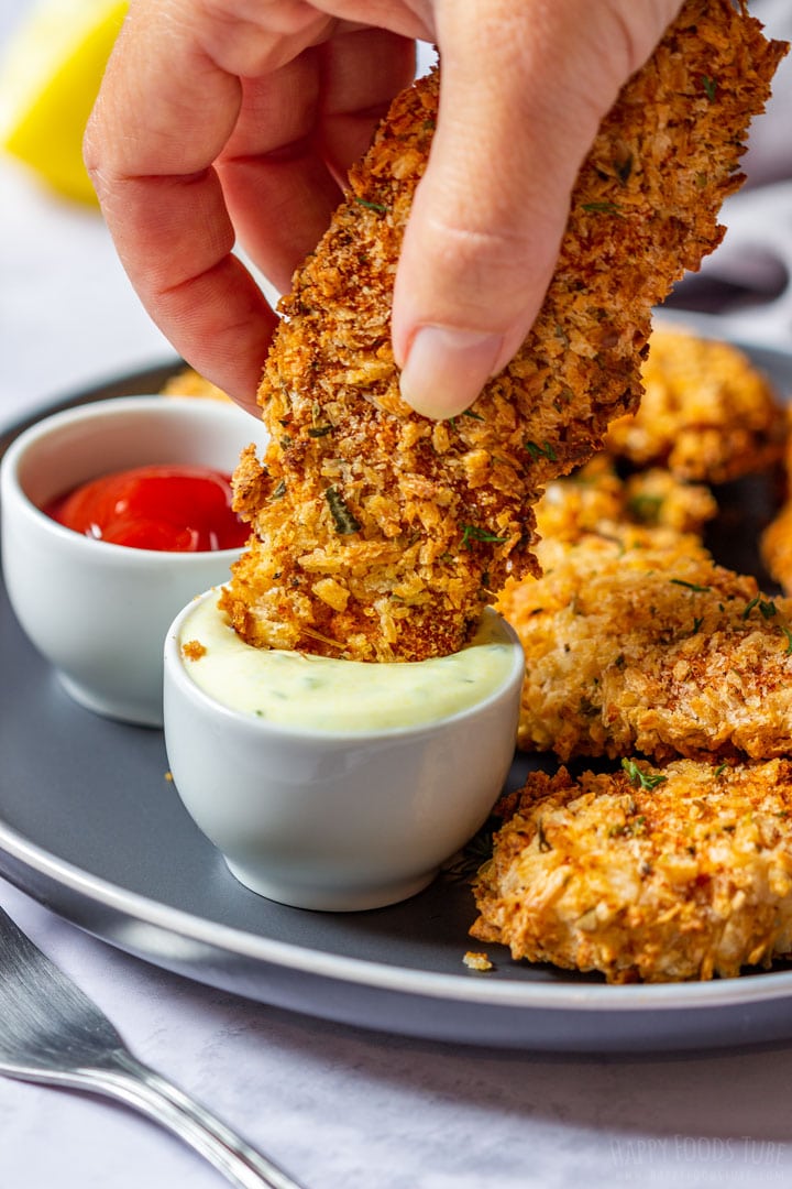 Dipping chicken tender to the garlic sauce