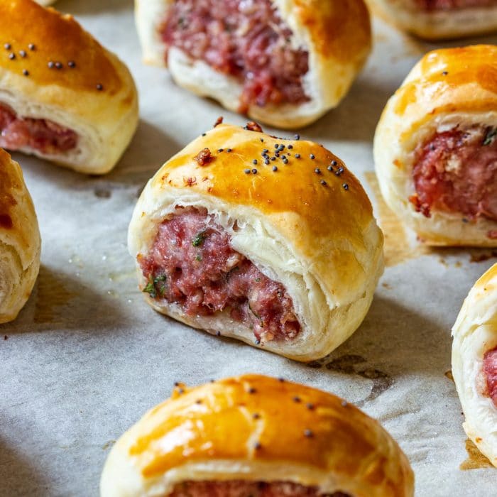 Homemade puff pastry sausage rolls on the baking tray