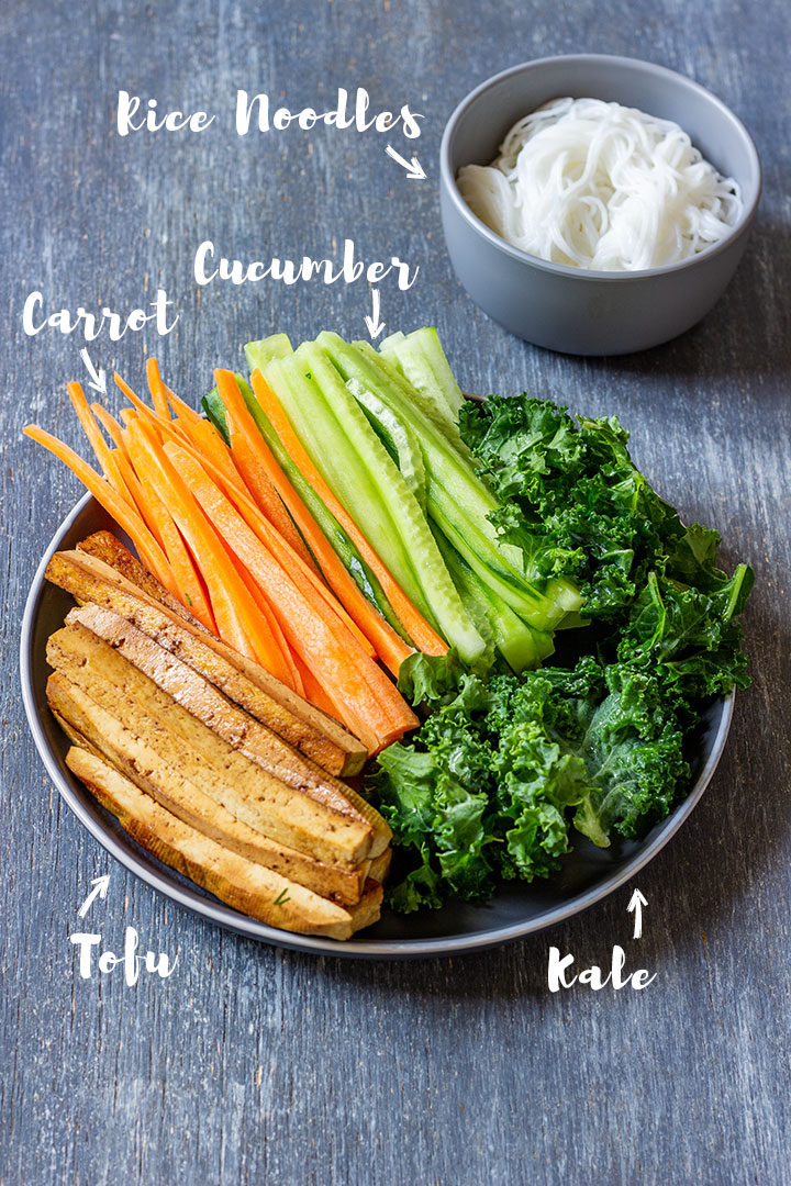 Fresh ingredients for spring rolls - carrots, cucumber, cale, tofu and rice noodles