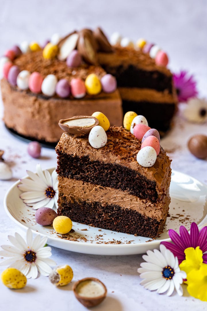 Slice of chocolate Easter cake with colorful mini Easter eggs