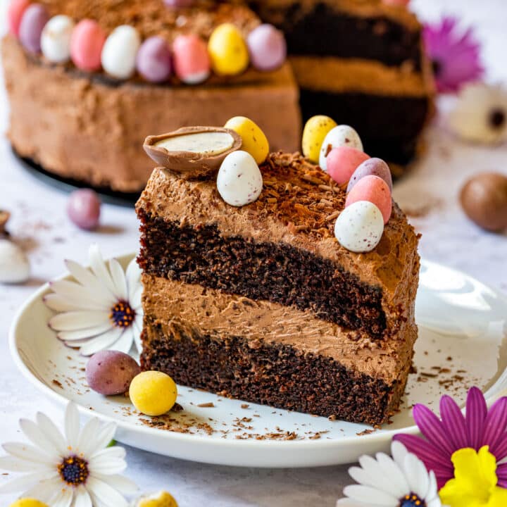 Close-up of a chocolate Easter cake slice decorated with colorful candy eggs.