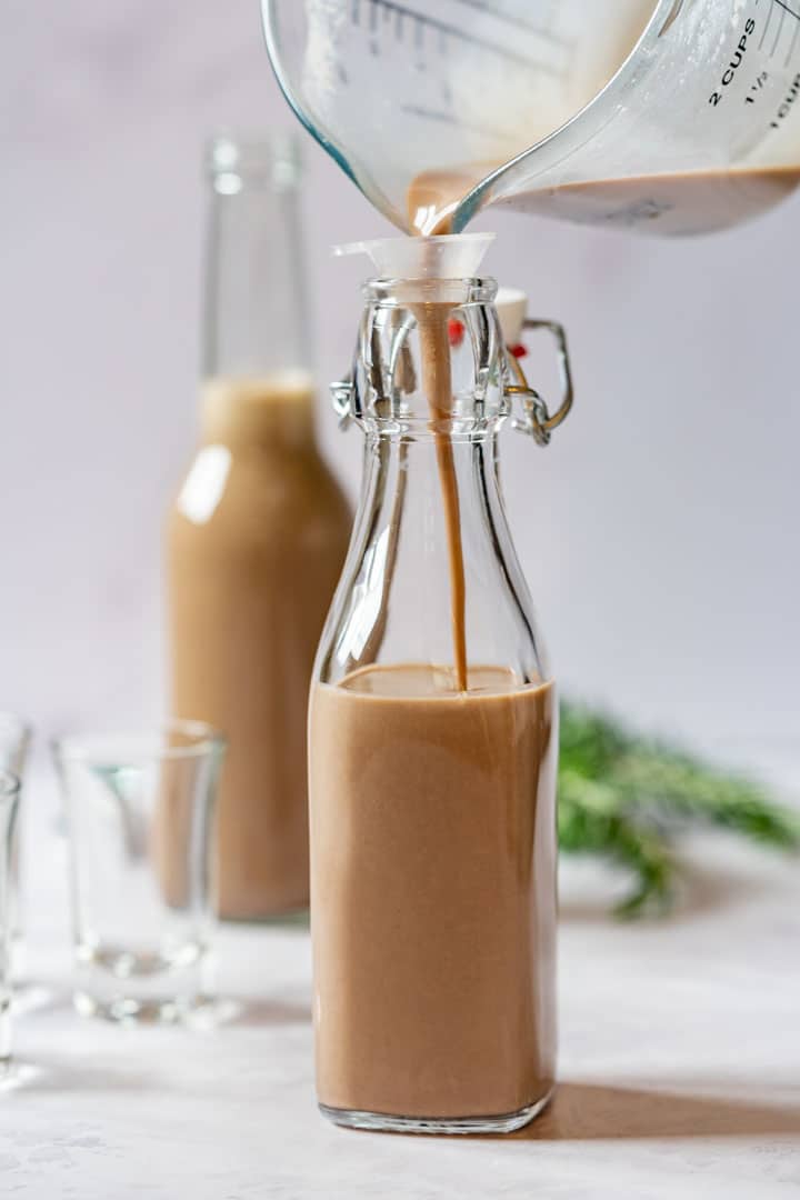 Pouring Irish cream to the small bottle