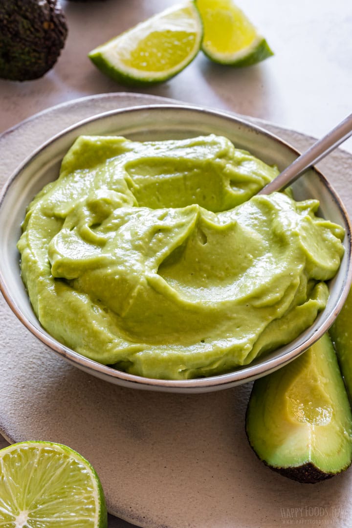 Bowl of vegan mayo with spoon in.