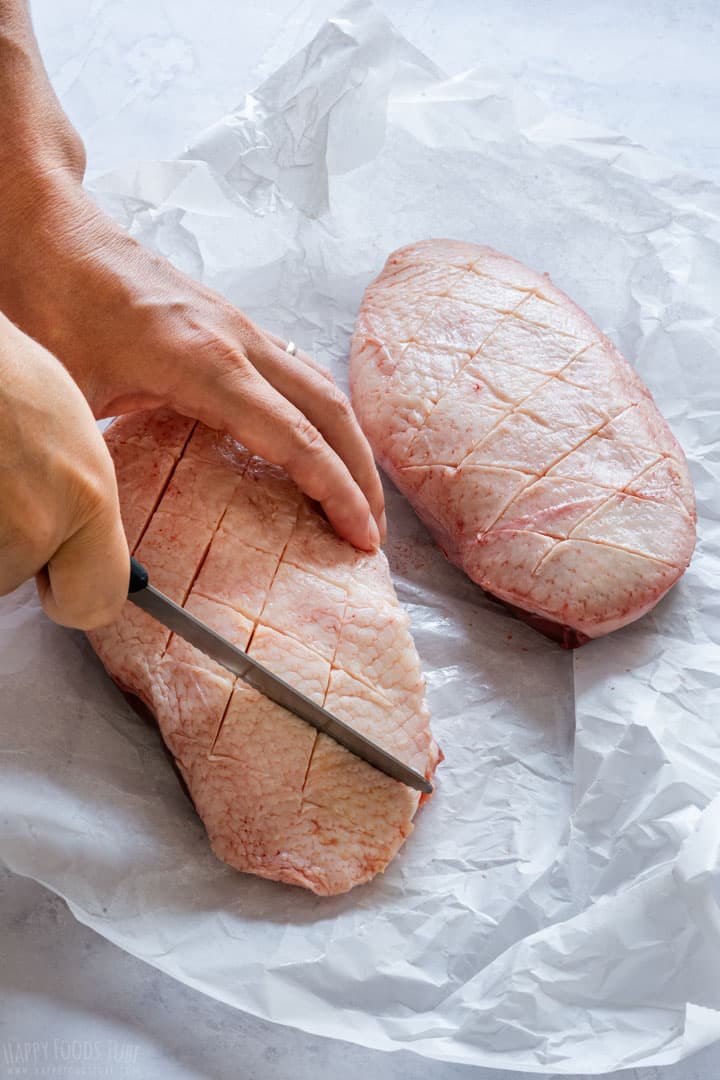 Showing how to score duck breast skin.