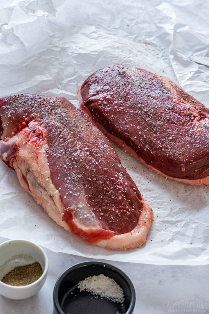 Uncooked seasoned duck breasts.