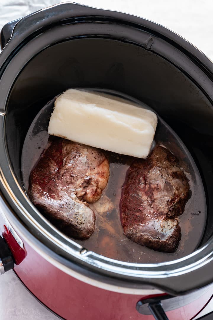Cooked duck breasts in the slow cooker with pork lard.