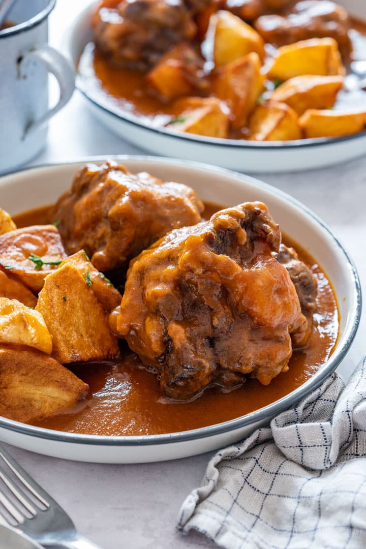 Pressure cooker oxtail stew served with potatoes and sauce.