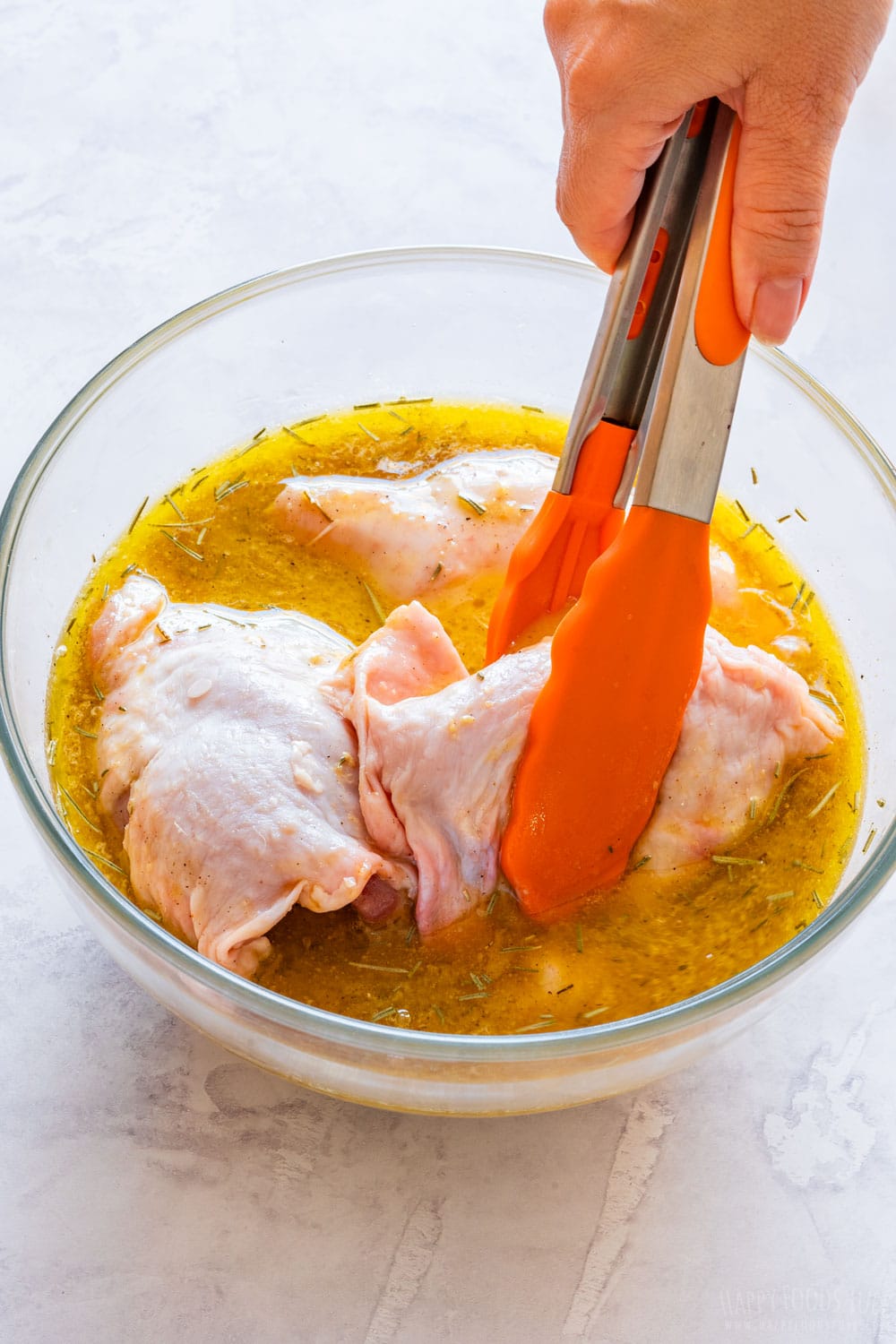 Adding chicken thighs to beer homemade beer marinade.