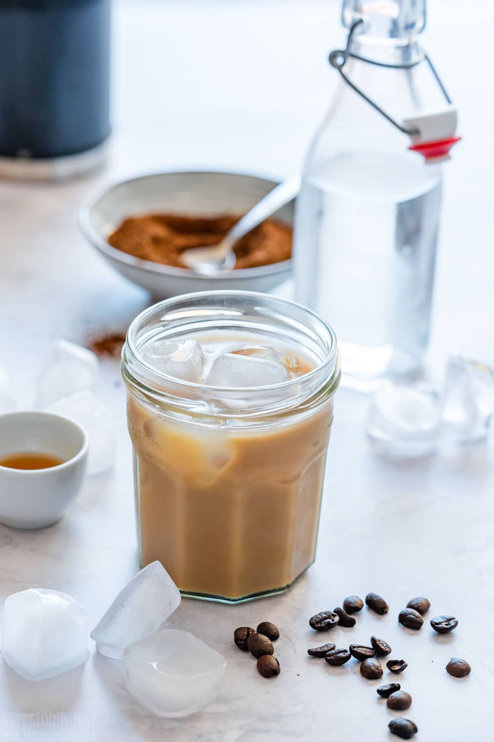 Refreshing and cooling iced latte with all the ingredients around.