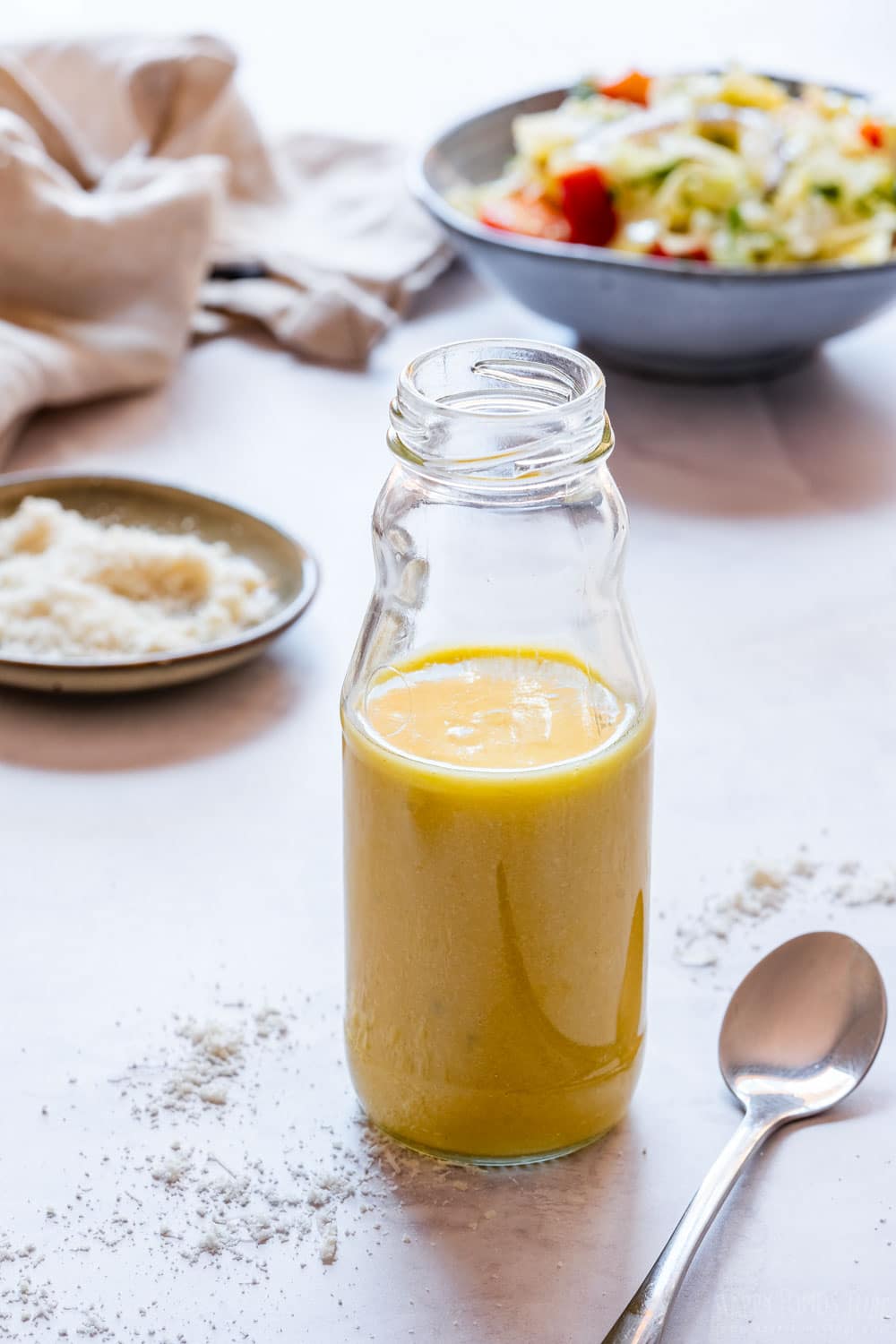 Parmesan vinaigrette and salad in the background.