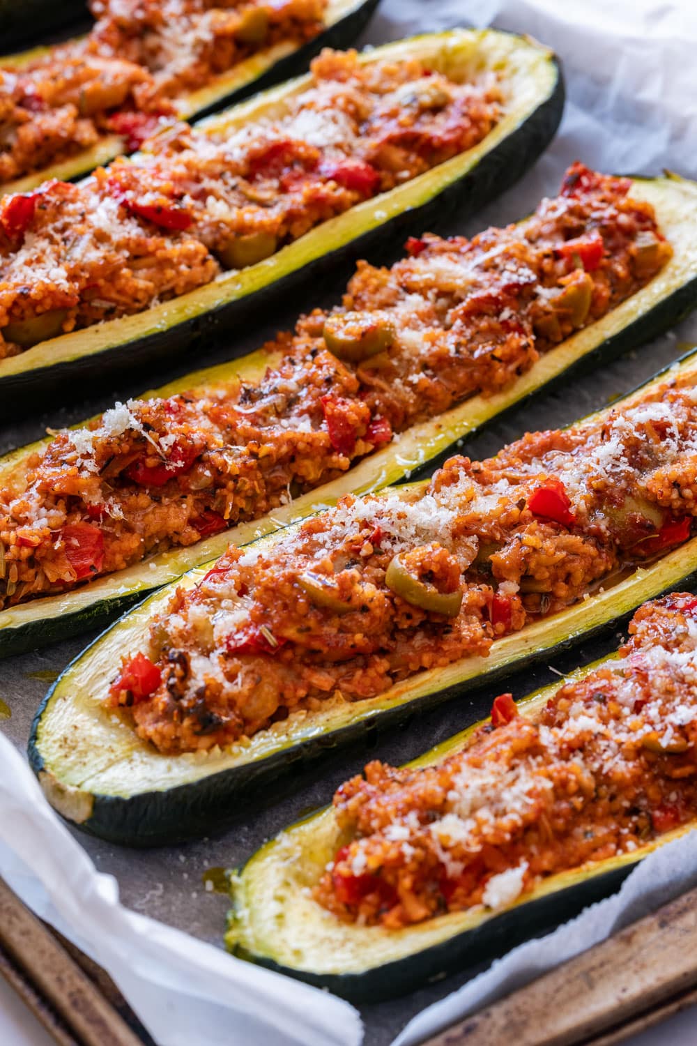 Stuffed zucchini boats on the baking tray.